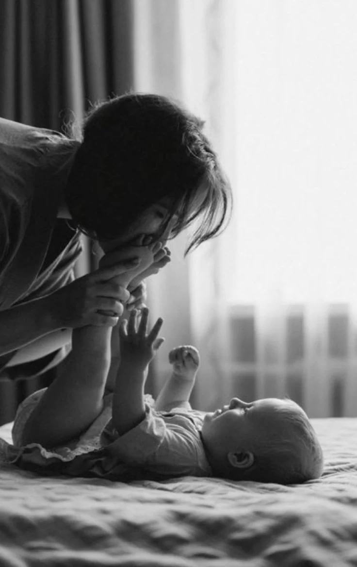 A parent playing gently with a baby